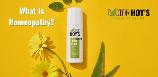 Photo of the Pain Relief roll-on with flowers on a yellow background